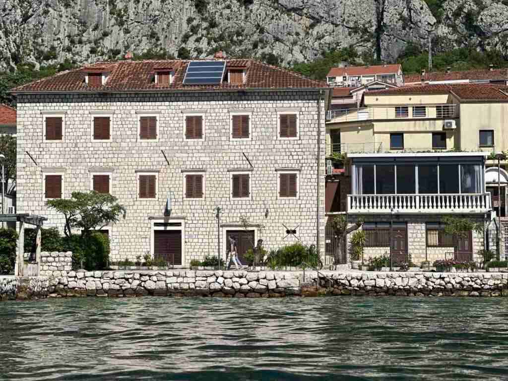 The old stone house of Garni hotel Pana seen from the Bay of Kotor