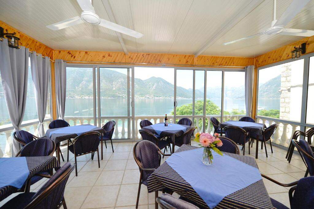 Glazed breakfast terrace of the hotel facing the sea and mountains
